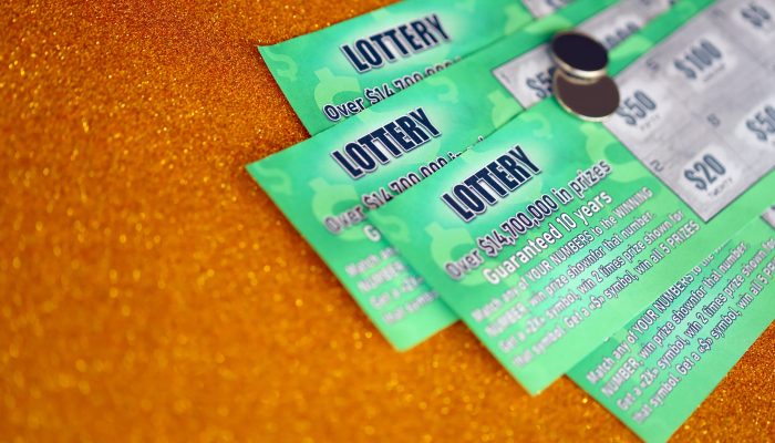 Close up view of green lottery scratch cards. Many used fake instant lottery tickets with gambling results. Gambling addiction concept.